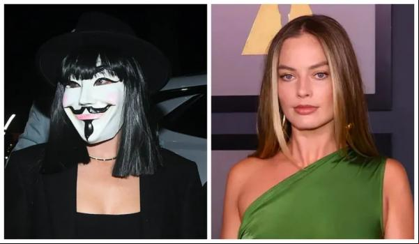 Margot Robbie com a máscara do protagonista de V de Vingança na festa de Halloween promovida por George Clooney e Rande Gerber.(Imagem:Getty Images)
